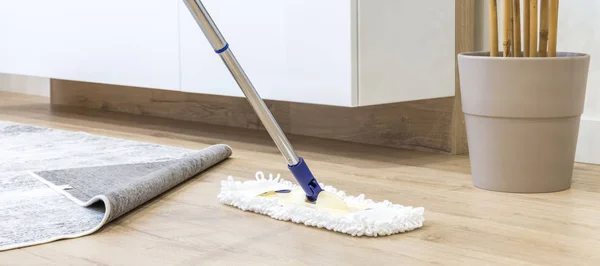 Wooden floor with white mop, cleaning service concept — Stock Photo, Image