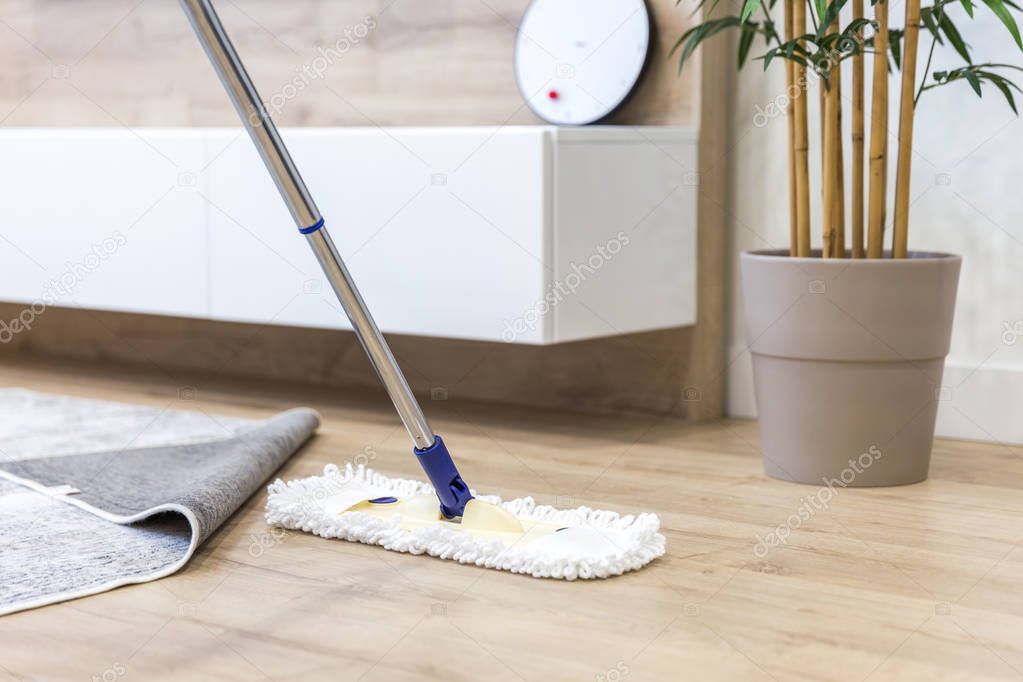 Wooden floor with white mop, cleaning service concept