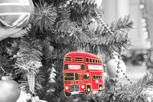 Christmas tree decoration with red british bus. Black and white style — Stock Photo, Image