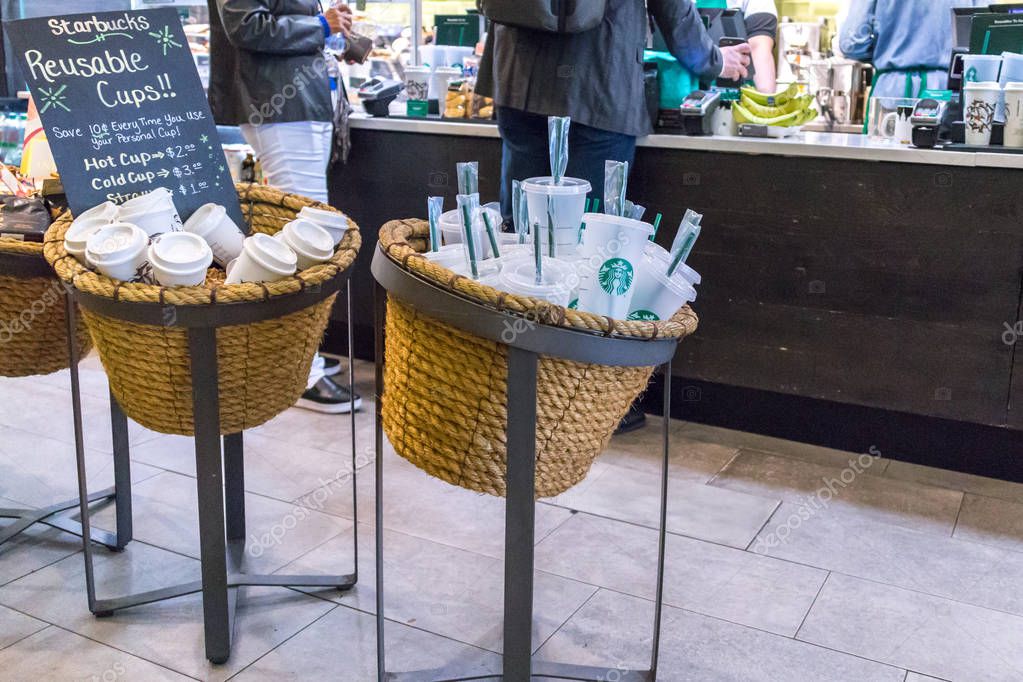 NEW YORK, USA - 17 MAY, 2019: Starbucks reusable coffee cups on sale in cafe in New York. People who use their own cup get discount for coffee