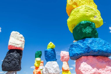 Las Vegas, Nevada, ABD - 12 Mayıs 2019: Las Vegas şehri yakınlarındaki Seven Magic Mountains sanat enstalasyonu. Neon renkli kayalardan yapılmış sütunlar çorak çöl arka plan ve mavi gökyüzüne karşı durmak.