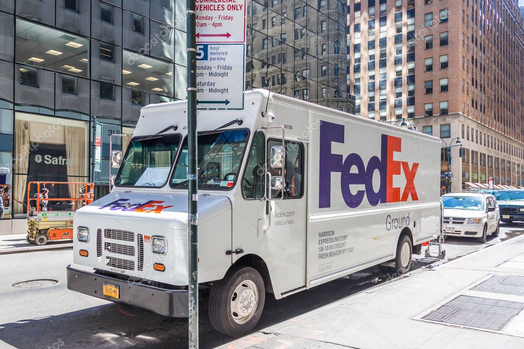 NEW YORK, USA - MAY 15, 2019: FedEx Express truck in midtown Manhattan. FedEx is one of the leading package delivery services offering many different delivery options