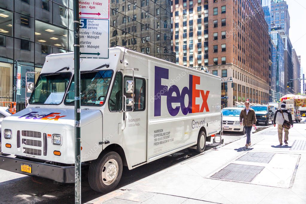 NEW YORK, USA - MAY 15, 2019: FedEx Express truck in midtown Manhattan. FedEx is one of the leading package delivery services offering many different delivery options