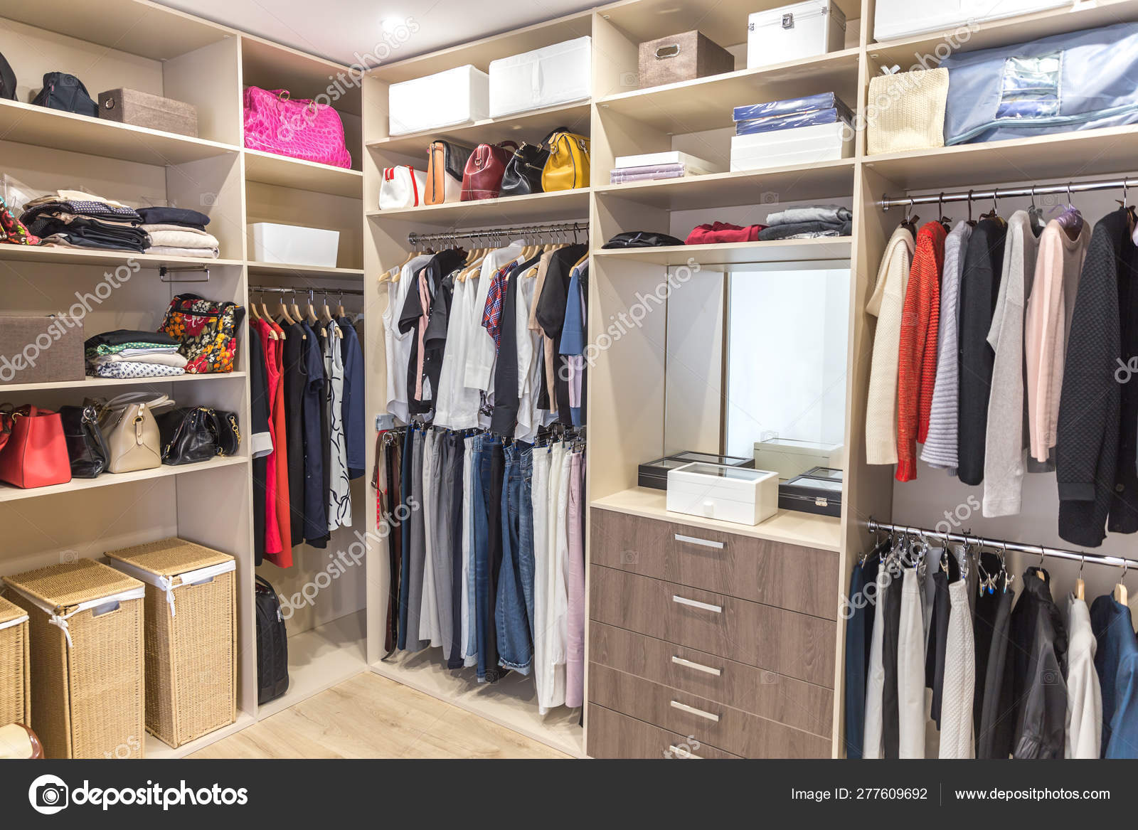 Big Wardrobe With Different Clothes For Dressing Room