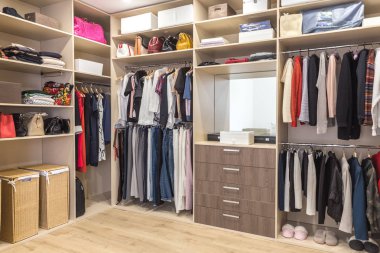 Big wardrobe with different clothes for dressing room clipart