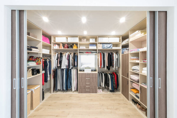 Big wardrobe with different clothes for dressing room