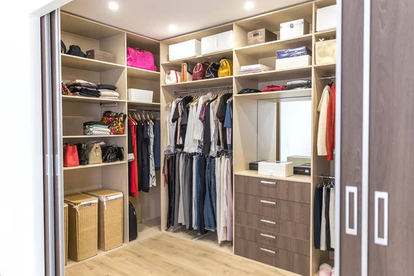 Big wardrobe with different clothes for dressing room