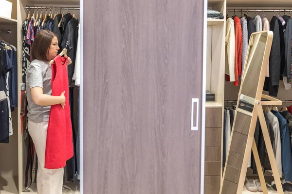 Mujer en gran armario de walkin elegir la ropa. armario moderno y vestidor con espacio para copiar — Foto de Stock