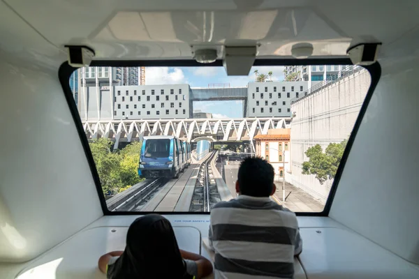 迈阿密- 2019年9月10日：迈阿密市中心全自动铁路系统，以城市为背景。 父子俩，从火车里望过去 — 图库照片