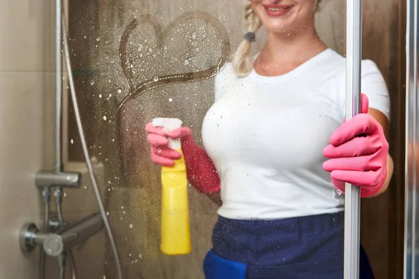 Jonge vrouw achter douche glas met hart tekening op het — Stockfoto