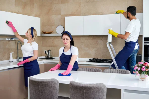 Cleaning service team at work in kitchen in private home — Stock Photo, Image