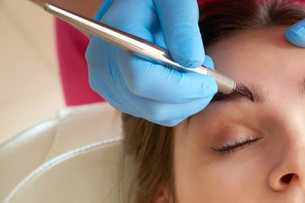 Professional eyebrow correction in beauty salon