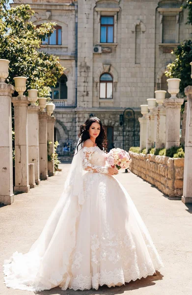 时尚户外照片美丽的新娘与深色的头发在豪华婚纱摆在优雅的别墅 — 图库照片