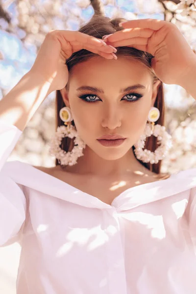 Hermosa mujer joven en vestido elegante y pendientes de lujo po — Foto de Stock