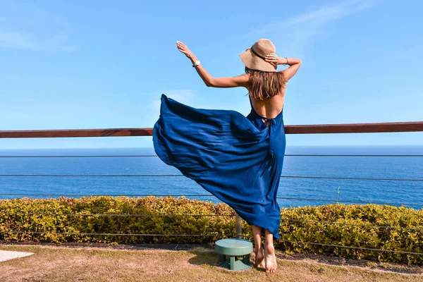 Beautiful woman with dark long hair in elegant blue dress posing — Stock Photo, Image