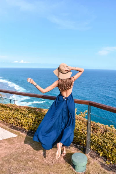Beautiful woman with dark long hair in elegant blue dress posing — Stock Photo, Image