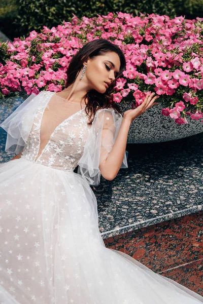 Schöne Frau mit dunklen Haaren im luxuriösen Hochzeitskleid — Stockfoto