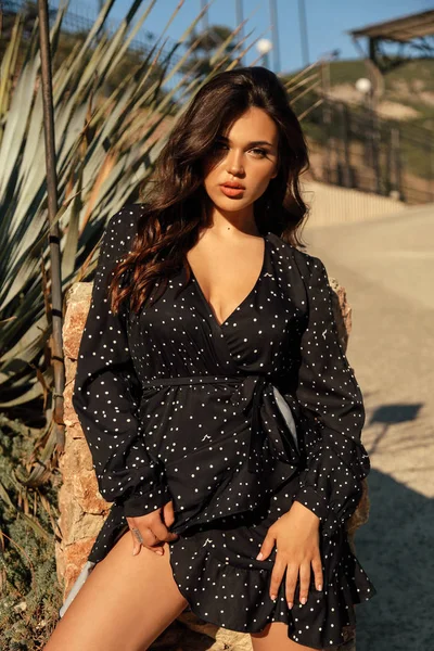 Hermosa mujer con cabello oscuro en vestido elegante posando en verano — Foto de Stock