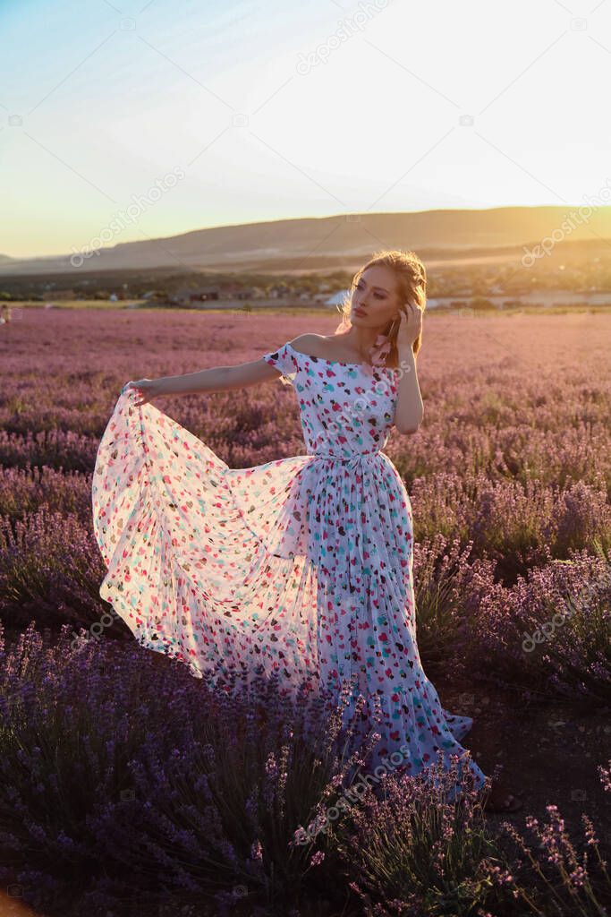 fashion outdoor photo of beautiful sexy woman with blond hair in elegant clothes with accessories posing in blooming lavender fields