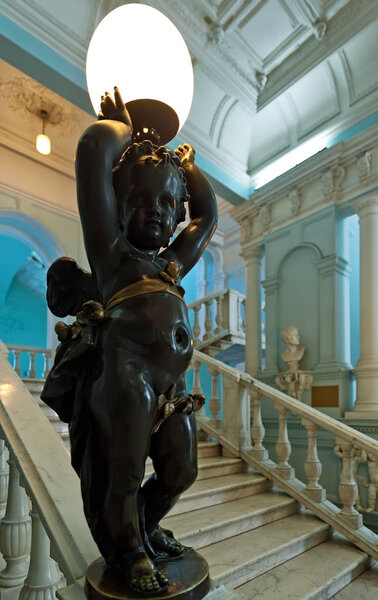 The sculpture cupid lamp in the hall of Odesa Museum of Western and Eastern Art, Odesa Ukraine
