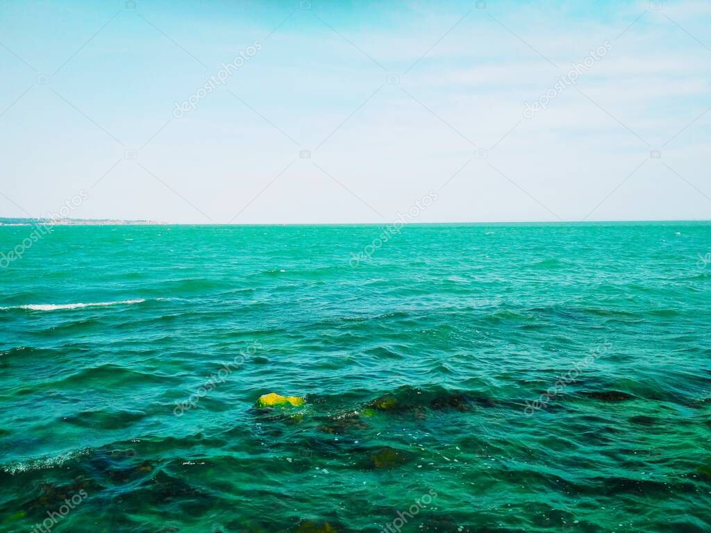 Wavy Black Sea with some underwater stones 