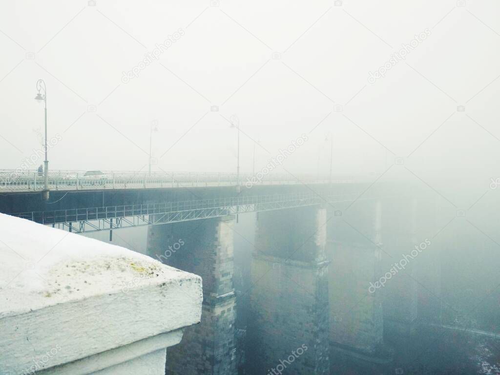 Bridge over canyon on a dull foggy winter day, Kamenets-Podolsky, Ukraine 