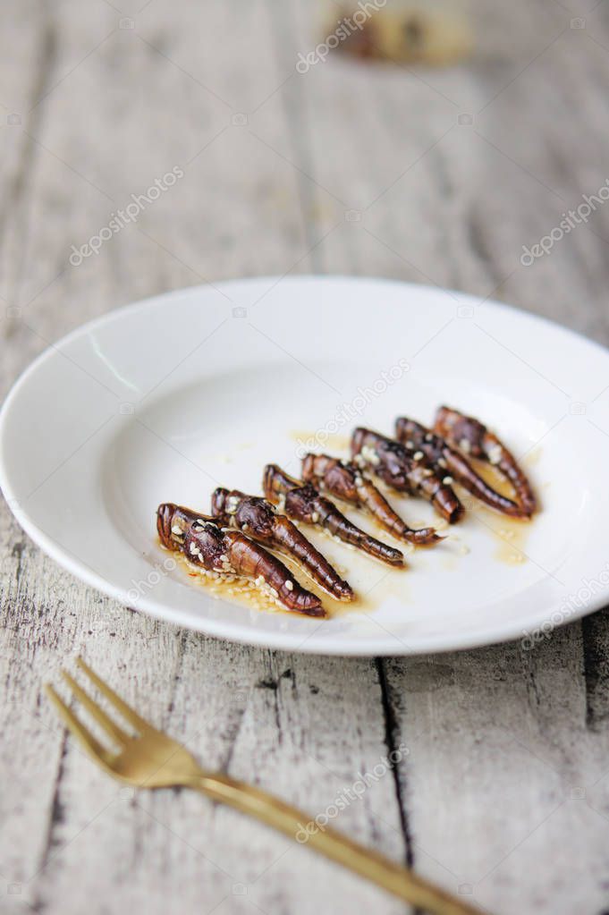 Roasted grasshoppers coated with honey and sesame seeds