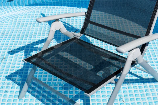 Black chair to relax in the swimming pool