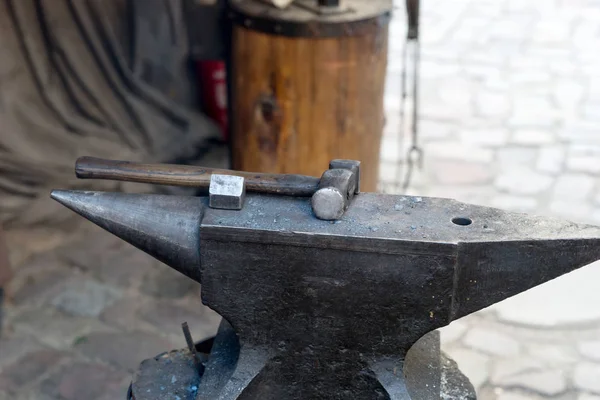 Hammer lies on the anvil in the blacksmith\'s workshop