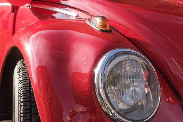 Turn signals and headlights. Front view of car in red color