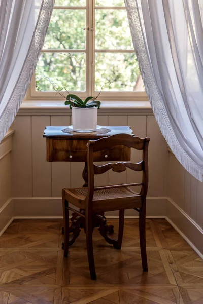 Vintage room with table and chair in front of the window in old rural house