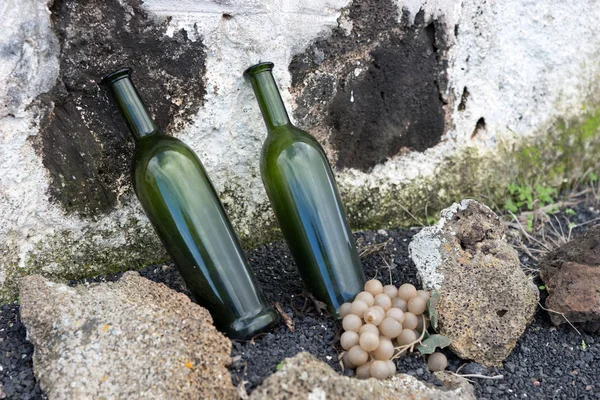 Two empty wine bottles as advertising in front of the entrance of the winery in Lanzarote