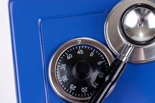Closeup stethoscope and closed blue safe