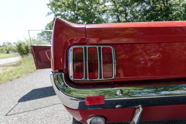 Tail light from an old red cabriolet. Detail of red old muscle car