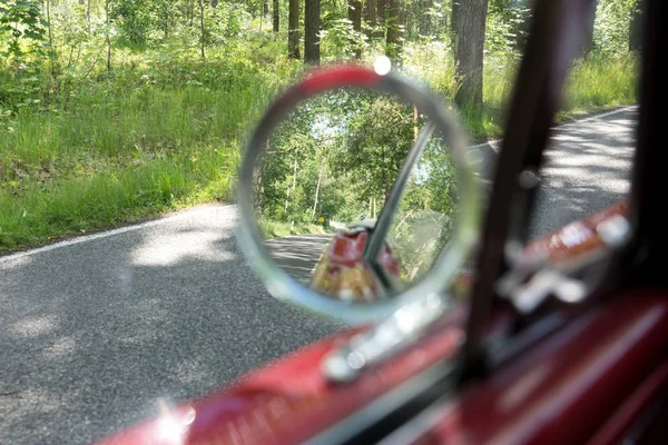 Round rear view mirror outside the retro car. Rear View mirror in the Cabriolet