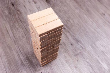 Tower of blocks made of wooden bricks isolated on the floor