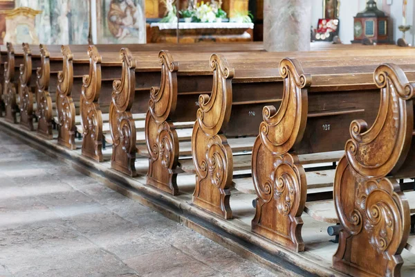 Empty wooden Church pews inside a Christian church