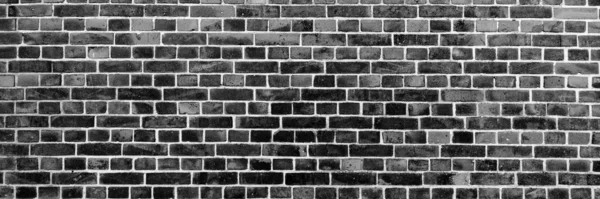 Panoramic image of black brick wall. Texture of black brick wall. Background of black brick wall