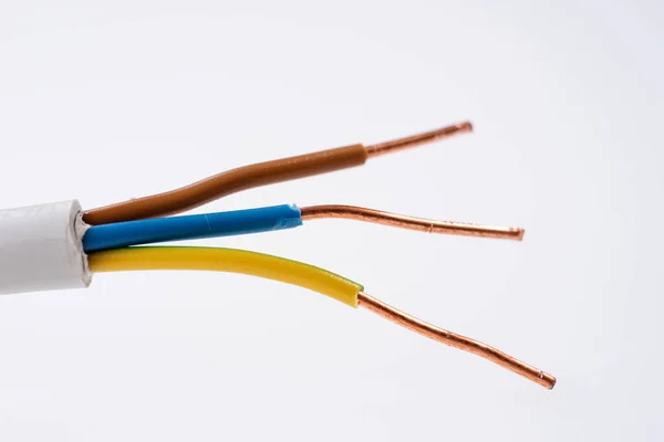 Flexible Three-wire electrical cable isolated on white background. Copper cable in color insulation