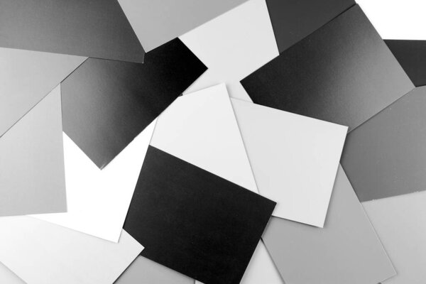Background of black and white paper sheets. Many sheets of black and white paper