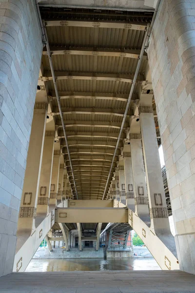 Perspective view underneath of the bridge. Concrete and metal structure.