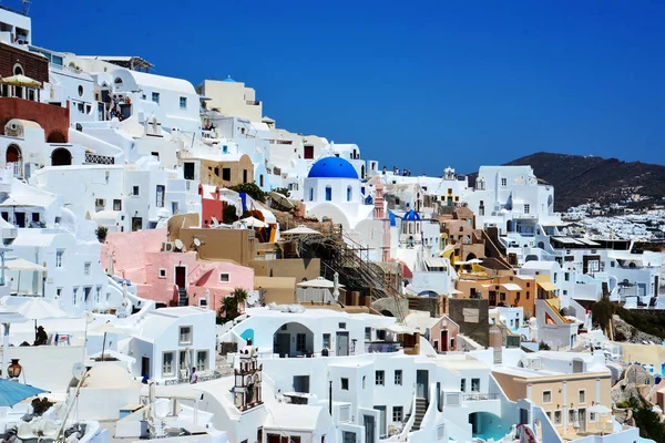 View of Santorini, famous Greek island that is part of the Cyclades, group of islands aligned in a cylindrical way. Santorini is one of the most beautiful Greek islands, with its white tiered houses, and its churches with blue dome.