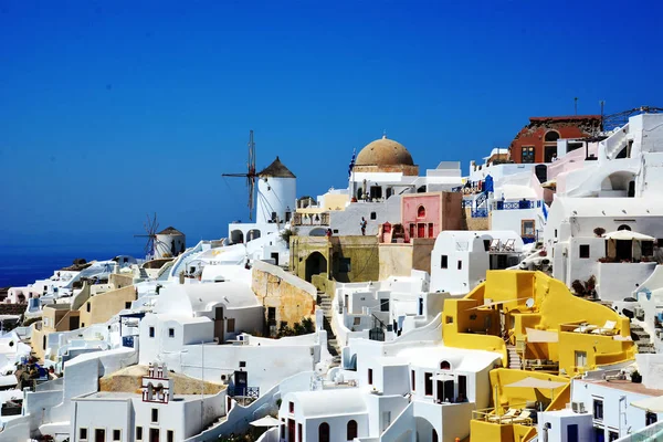 View of Santorini, famous Greek island that is part of the Cyclades, group of islands aligned in a cylindrical way. Santorini is one of the most beautiful Greek islands, with its white tiered houses, and its windmills