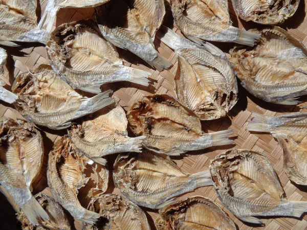 Salted fish drying process with a natural background. Raw fish. Indonesian (Javanese) called ikan balur. It is a traditional famous side dish in Indonesia.