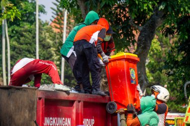 İnsanlar yangından sonra çevreyi temizlemek için birlikte çalışırlar..