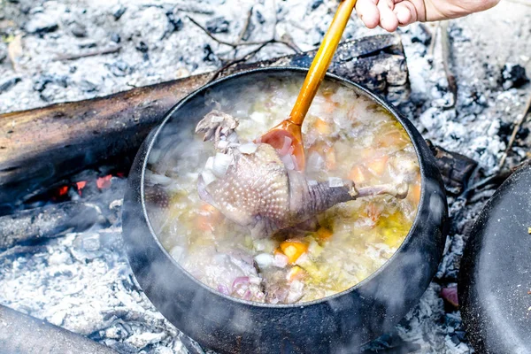 Soup is cooked in a tourist pot on the fire — Stock Photo, Image