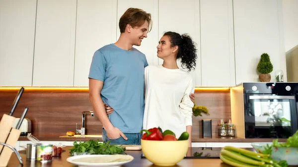 Happy couple, vegetarians cooking in the kitchen together. Young man and woman preparing healthy meals, sandwiches and salads. Vegetarianism, healthy food, diet concept — Stock Photo, Image