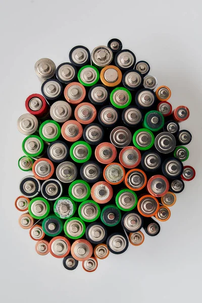 Top view of many alkaline batteries on white background. Concept of recycling waste and environmental pollution — Stock Photo, Image