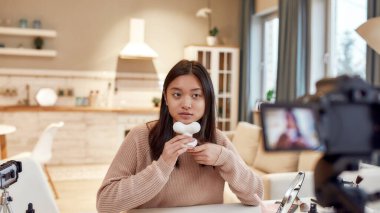Yarın için güzellik. Genç bayan blogcu güzellik blogu için video çekerken çenesine yüz masajı yapıyor. Yüz gerdirme, yaşlanma karşıtı tedavi konsepti