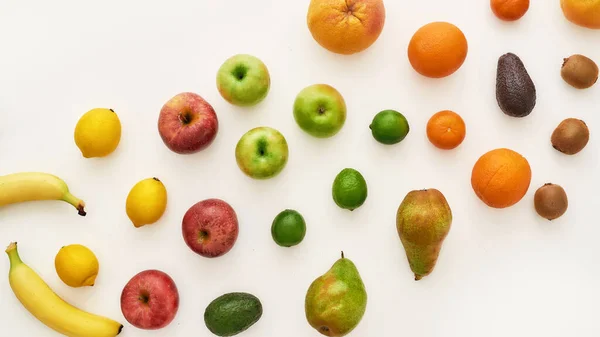 Top view of rainbow composition of various colorful fresh fruits isolated over white background